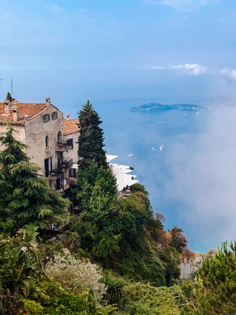 Stone buildings clinging to the cliffside as seen from the Jardin Exotique in Eze