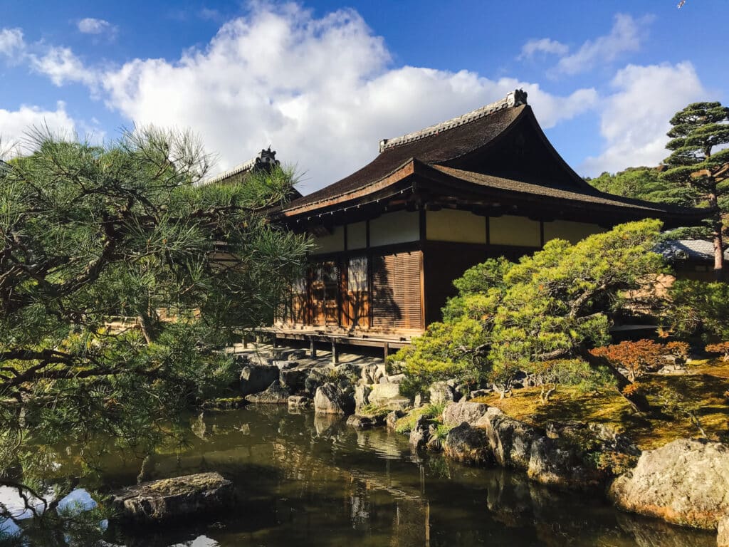 The Ginkaku-ji (silver pavillion ) temple, ponds, and gardens under a blue sky on a cold winter day