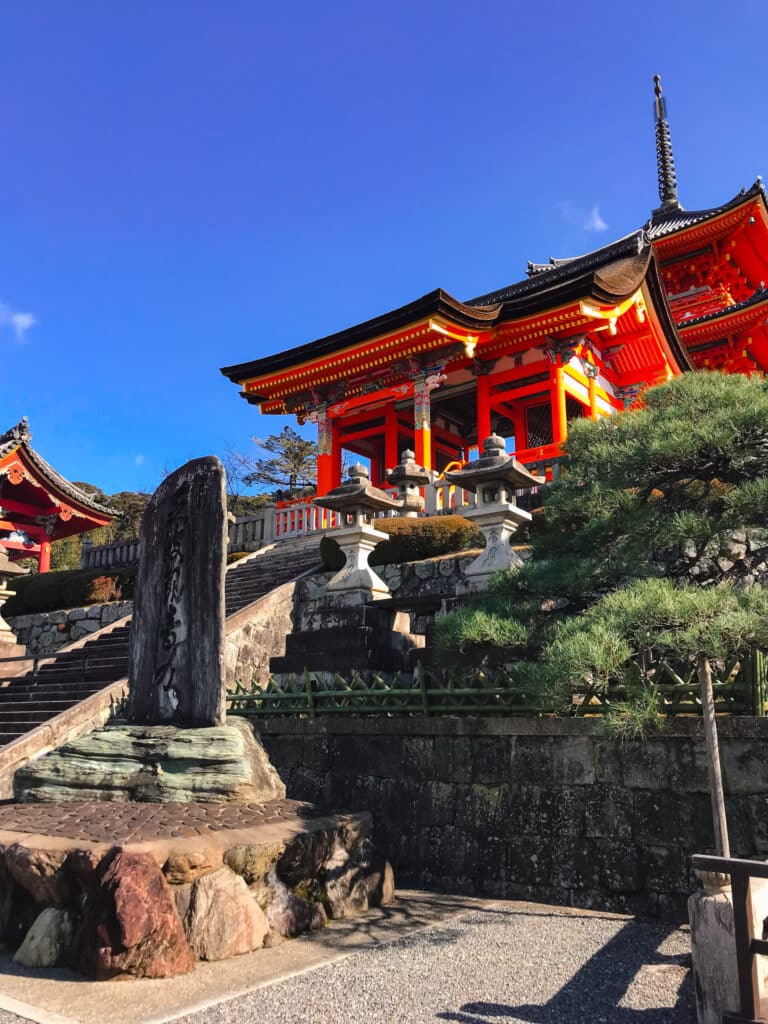 A temple building at kiyomizu-dera in Kyoto, with a decorative rock and bonsai tree