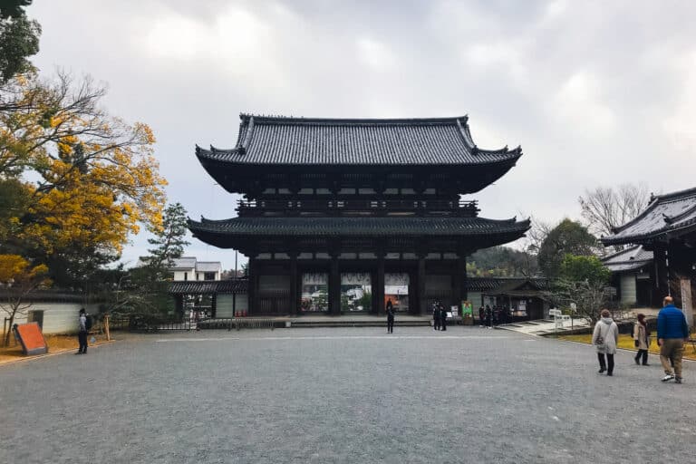 Visitors passing through the towering Nioumon gate at Ninna-ji, one of Kyoto's imperial temples.