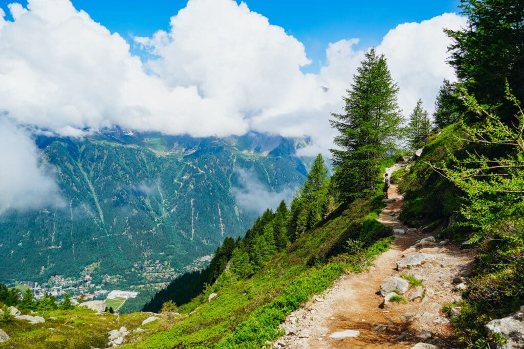 Sweeping view down the Grand Balcon Nord trail with the Chamonix valley and clouds layered below