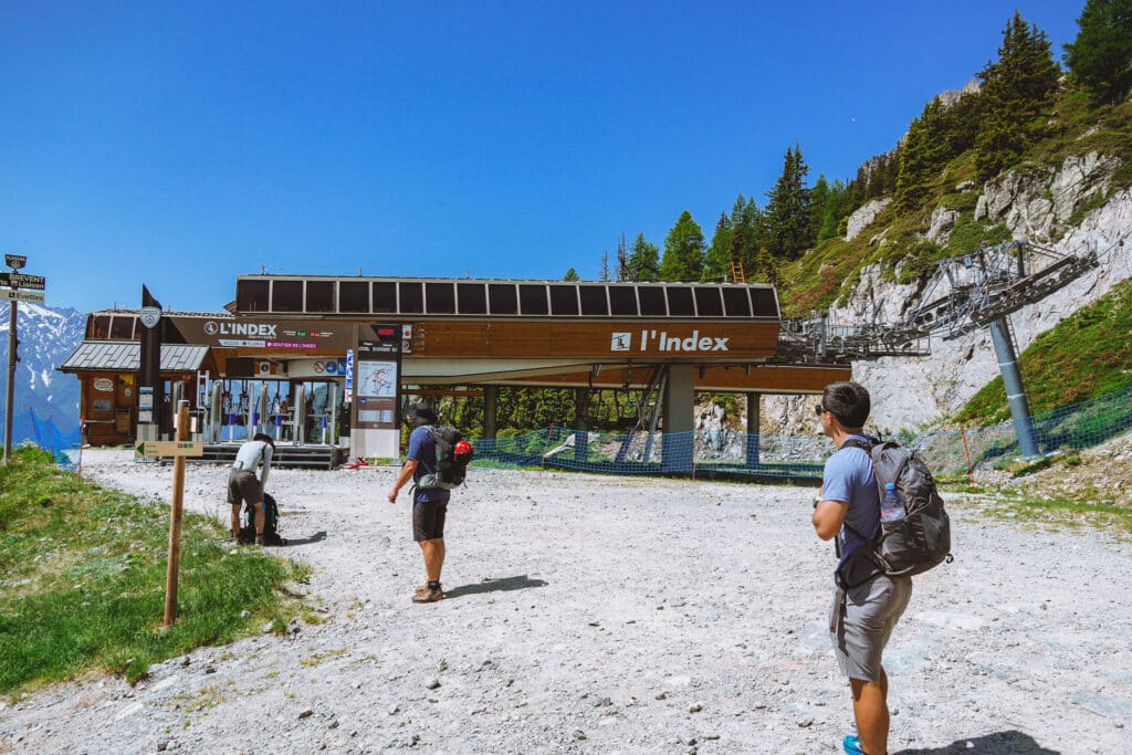 Hikers approaching L'Index chairlift, the upper lift option for shortening the steep climb to Lac Blanc in Chamonix