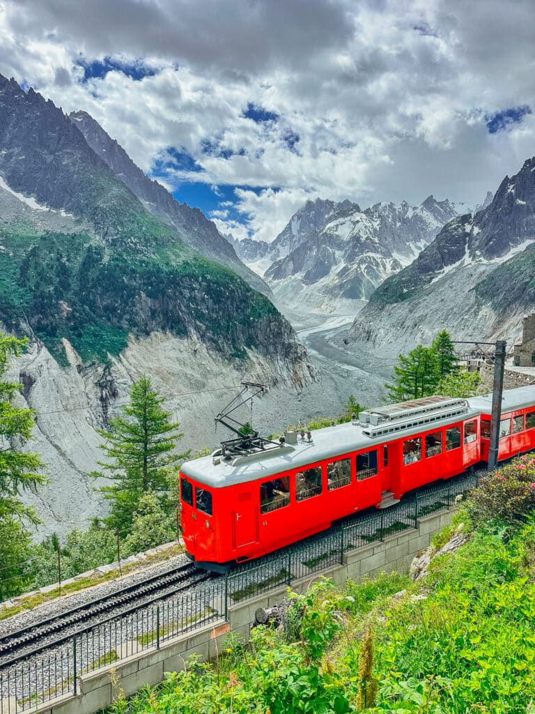 Red Montenvers cog train rolling toward the upper station above the Mer de Glace glacier in Chamonix
