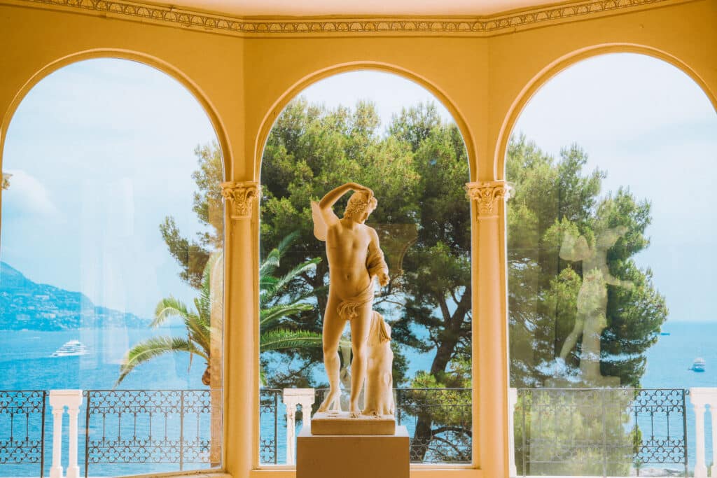 Statue framed by arched windows at Villa Ephrussi de Rothschild overlooking the Mediterranean Sea in Saint-Jean-Cap-Ferra