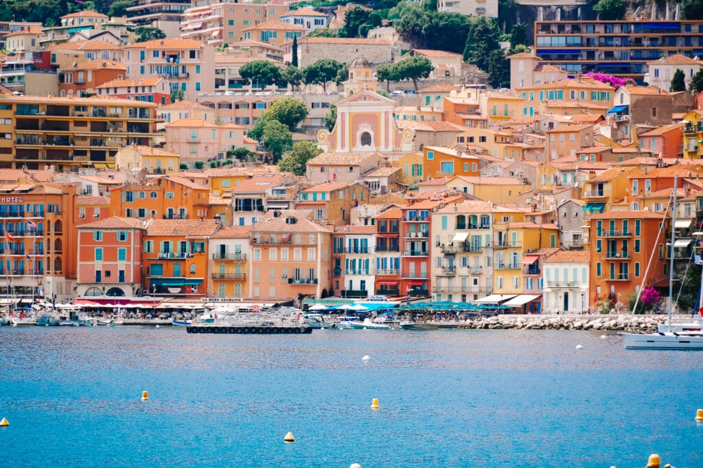 The warm painted houses in Villefranche-sur-Mer contrasted by the blue of the harbor