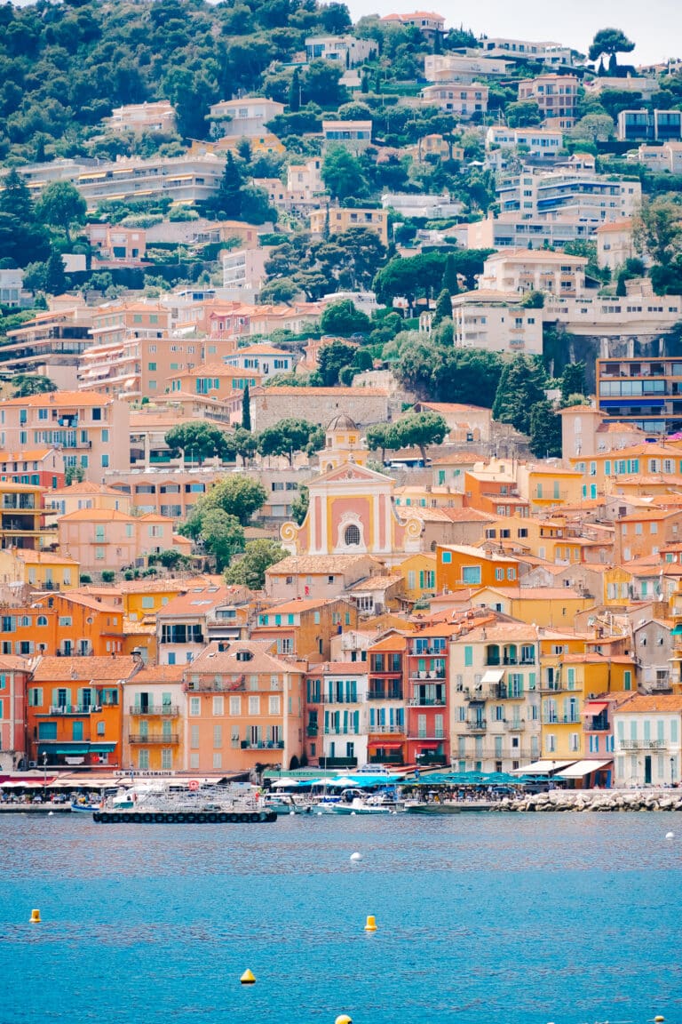 The warm painted houses in Villefranche-sur-Mer contrasted by the blue of the harbor