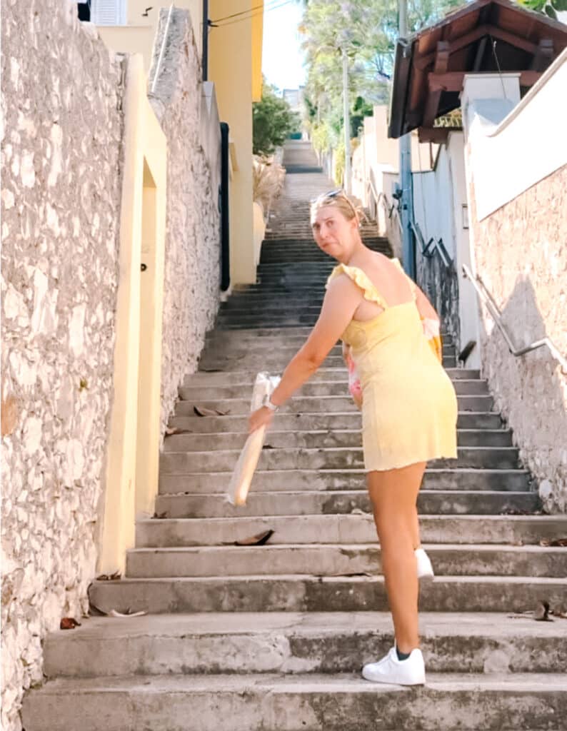 A traveler having a mental breakdown because she has to walk up over 1000 stairs to go home