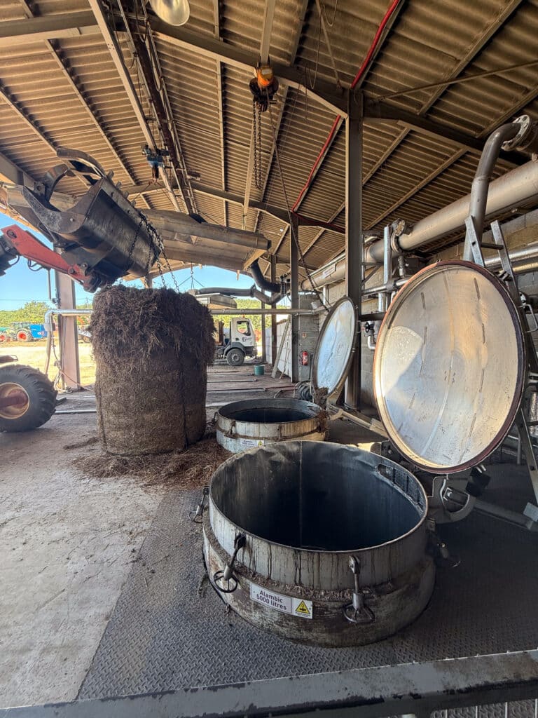 Copper distillation vats and lavender bales inside a working essential-oil distillery on the Sault plateau