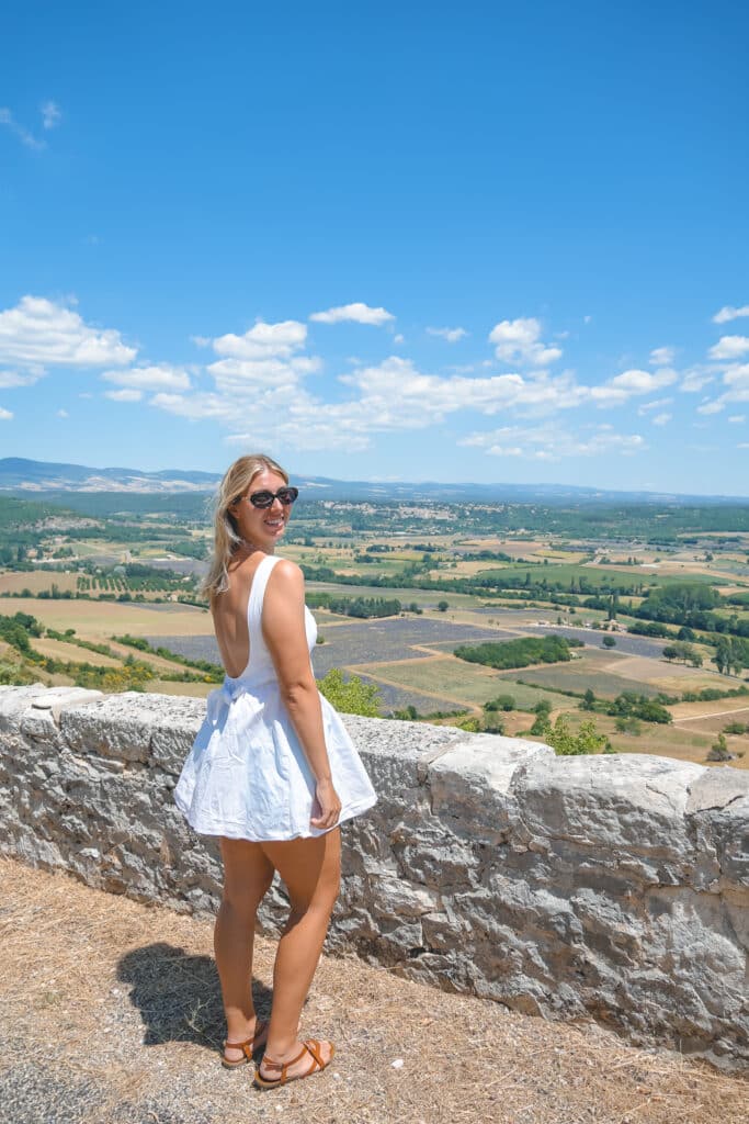 Traveler in a white summer dress on the Belvédère de Saint-Jean lookout near the Sault Plateau
