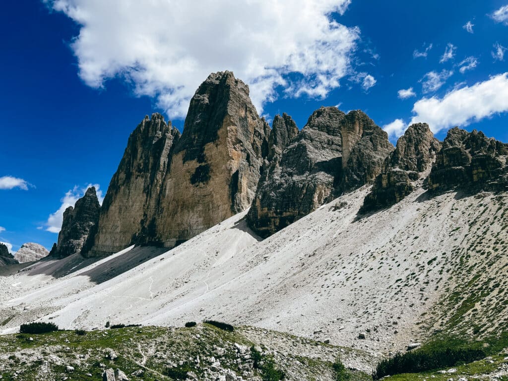 The multiple towers of Tre Cime in a row on a blue sky day