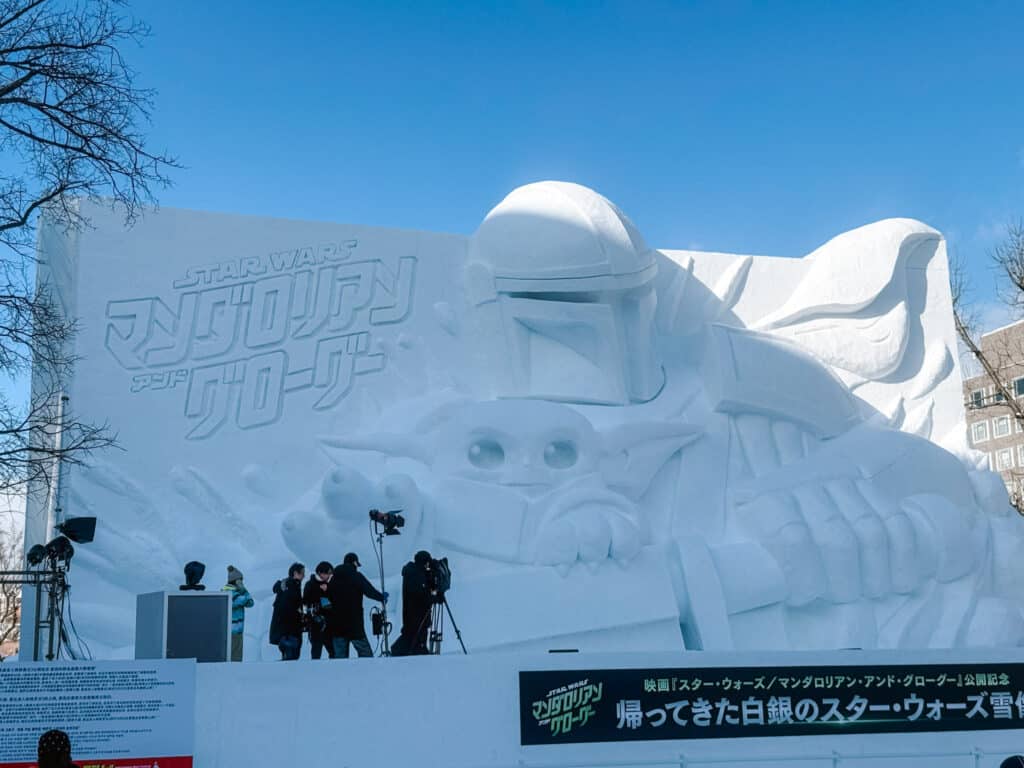 Giant Star Wars Mandalorian and Grogu snow sculpture on the main Odori Park stage, Sapporo Snow Festival, Japan