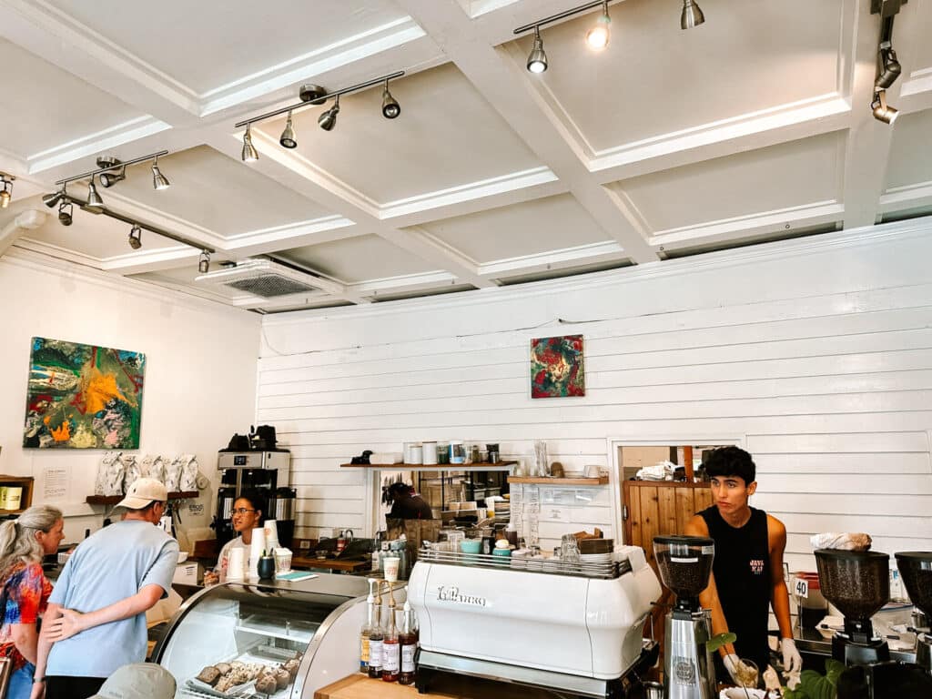 Baristas pulling espresso behind the counter inside Java Kai coffee shop in Kapaa, Kauai