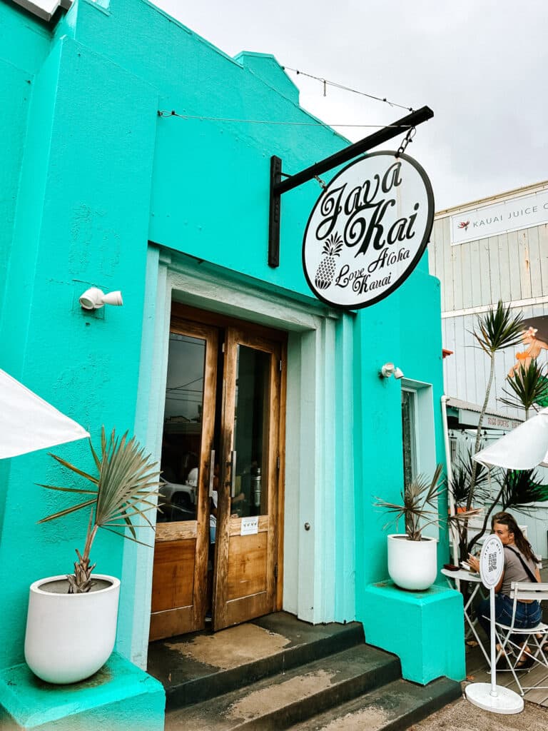 Turquoise storefront and hanging sign of Java Kai coffee shop in Kapaa, Kauai